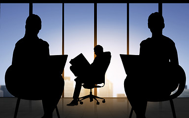 Image showing silhouette of business people working at office