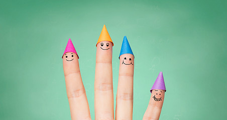 Image showing close up of hand with four fingers in party hats