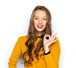 Image showing happy young woman or teen showing ok hand sign