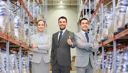 Image showing happy business team at warehouse showing thumbs up