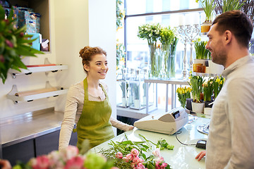 Image showing smiling florist woman and man at flower shop