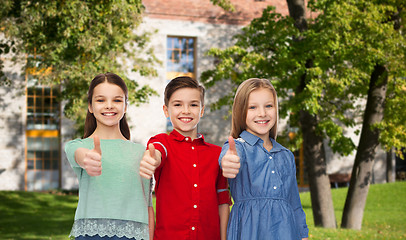 Image showing happy boy and girls showing thumbs up