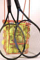 Image showing tennis racquets and ball hopper