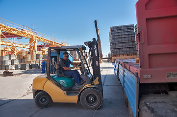 Image showing Loading sidewalk products in transport