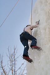 Image showing Girl climbs upward on ice climbing competition