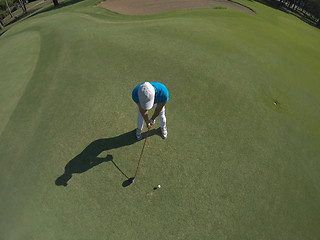 Image showing top view of golf player hitting shot