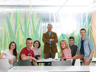 Image showing portrait of in teacher in classroom with students group in backg