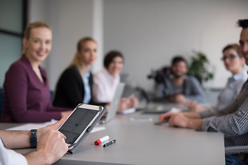 Image showing close up of  businessman hands  using tablet on meeting