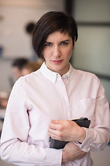 Image showing hispanic businesswoman with tablet at meeting room