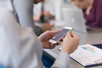 Image showing close up of  busineswoman hands  using smart phone on meeting