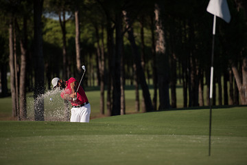 Image showing golfer hitting a sand bunker shot