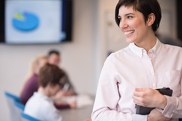 Image showing hispanic businesswoman with tablet at meeting room