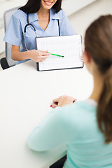 Image showing doctor showing cardiogram to patient at hospital