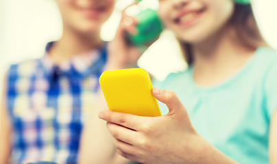 Image showing close up of girls with smartphone and headphones