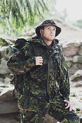 Image showing young soldier with backpack in forest