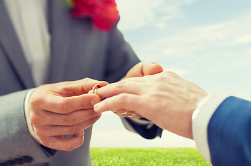 Image showing close up of male gay couple hands and wedding ring