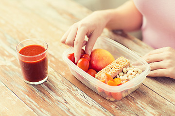 Image showing close up of woman with vegetarian food in box