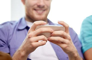 Image showing close up of happy man with smartphone at home