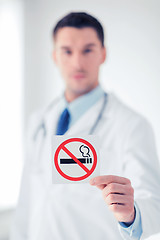 Image showing male doctor holding no smoking sign