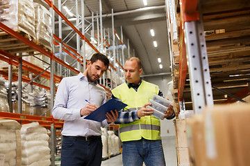 Image showing worker and businessmen with clipboard at warehouse