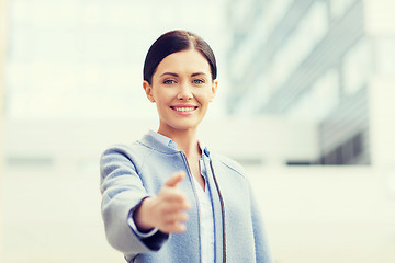 Image showing smiling businesswoman giving hand for handshake