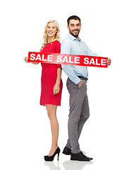 Image showing couple with red sale sign standing to back 