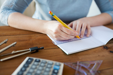 Image showing close up of hands with ruler and pencil drawing 