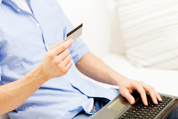 Image showing close up of man with laptop and credit card