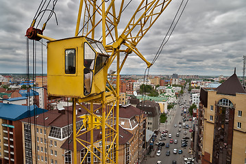 Image showing Construction crane over street traffic background