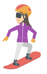 Image showing Young woman snowboarding.