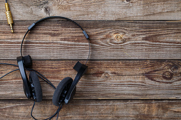 Image showing Headphones over wooden table.