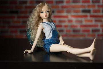 Image showing doll on a background of a brick wall.