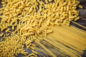 Image showing close up portrait of raw homemade italian pasta, macaroni, spaghetti, and fettuccine