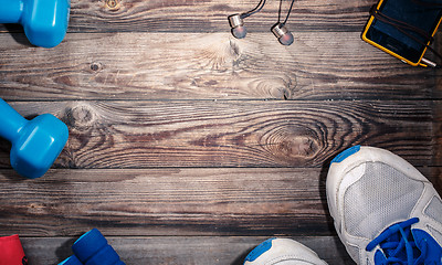 Image showing Sport stuff on wooden table, top view