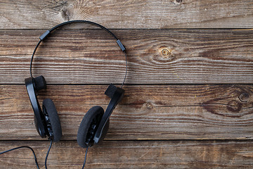 Image showing Headphones over wooden table.