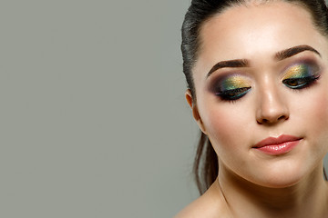 Image showing Close up portrait of beautiful young woman face. Makeup concept.
