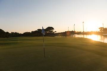 Image showing golf ball on edge of  the hole