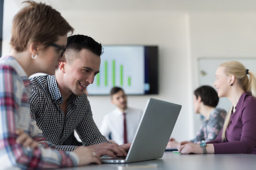 Image showing young business couple working on laptop, businesspeople group on