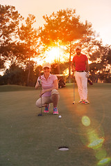 Image showing couple on golf course at sunset