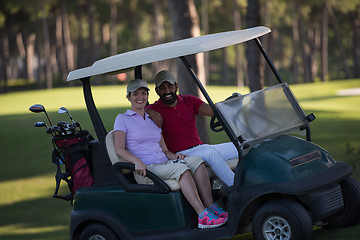 Image showing couple in buggy on golf course