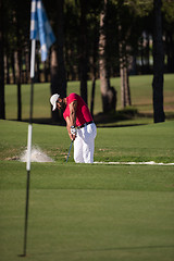 Image showing golfer hitting a sand bunker shot