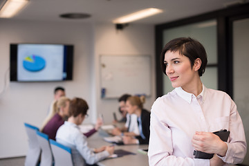 Image showing hispanic businesswoman with tablet at meeting room