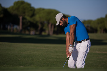 Image showing pro golfer hitting a sand bunker shot