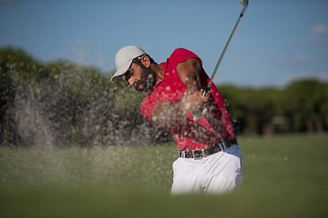 Image showing golfer hitting a sand bunker shot