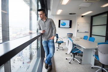 Image showing young business man using smart phone at office