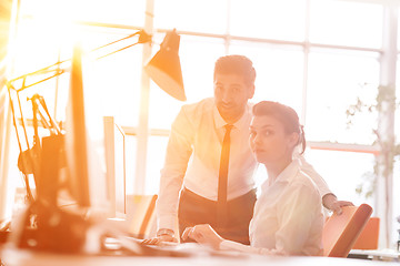 Image showing business couple working together on project, sunrise in backgrou