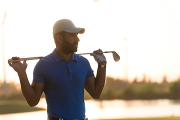 Image showing golfer  portrait at golf course on sunset