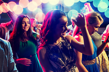 Image showing smiling friends dancing in club