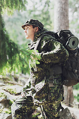 Image showing young soldier with backpack in forest