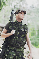 Image showing young soldier or hunter with gun in forest